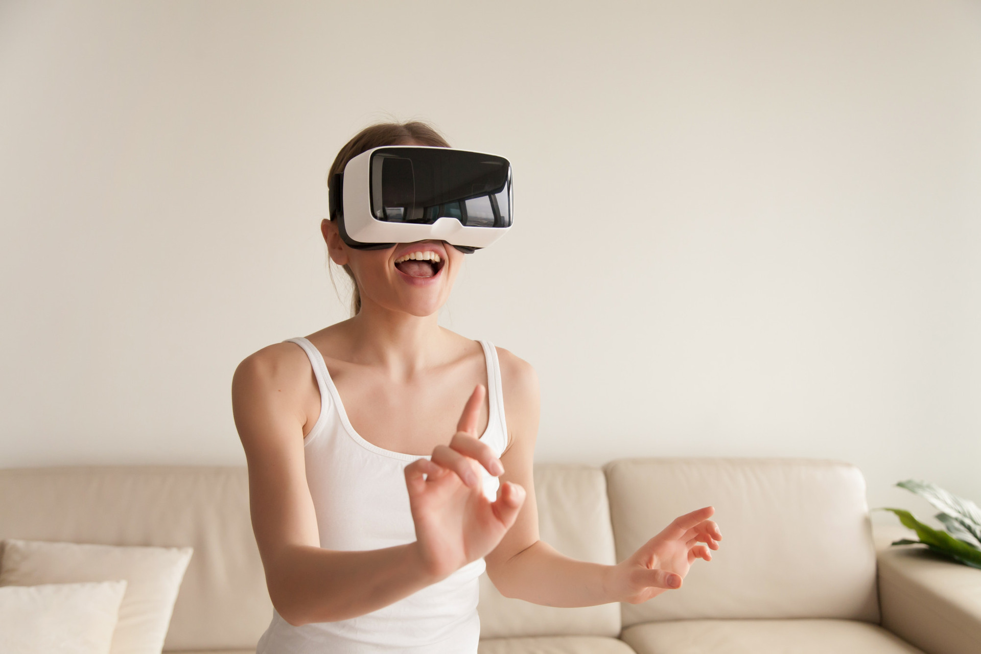 excited-young-woman-wearing-vr-headset-touching-virtual-reality-1920x1280