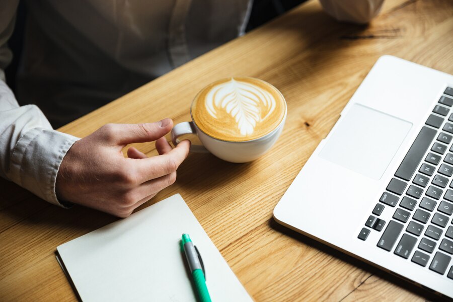 cropped-photo-mans-hand-white-shirt-holding-coffee-cup_171337-9994